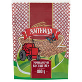 The 800g Zhitnica package of steam-treated buckwheat, labeled in Russian, features a red tractor and butterfly against a red and green design. Explore the nutritional details of this wholesome grain, perfect for health-conscious individuals.